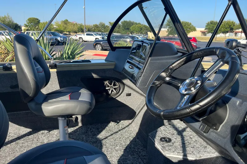 Slide: The Image of 2026 Tracker Targa V-18 WT boat interior with open storage compartment and control panel. - 3