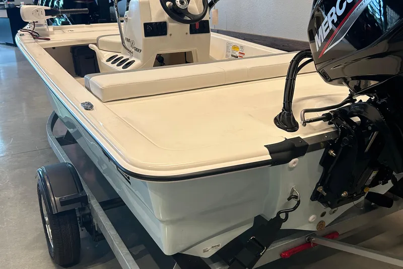 Slide: The Image of 2026 Mako Pro Skiff 13 CC boat on trailer, featuring a Mercury outboard motor. - 2