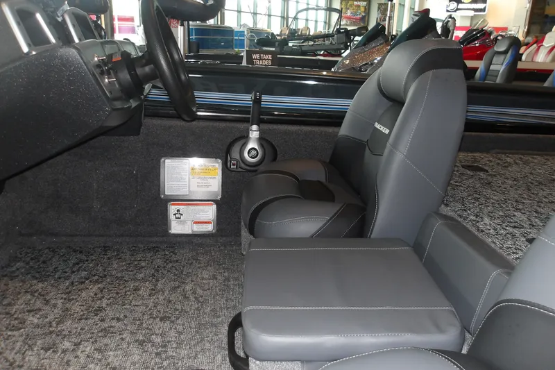 Slide: The Image of Interior of 2026 Tracker Pro Team 190 boat with gray seating and steering wheel. - 13