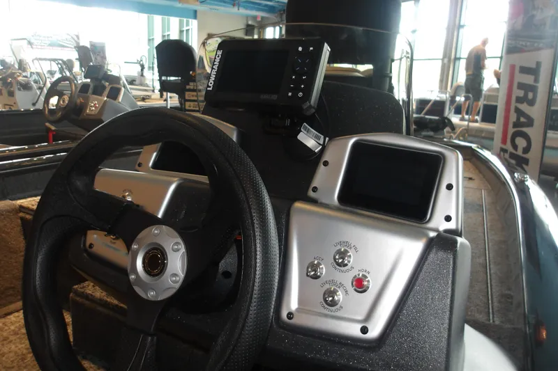 Slide: The Image of 2026 Tracker Pro Team 190 boat dashboard with steering wheel and electronic controls. - 15
