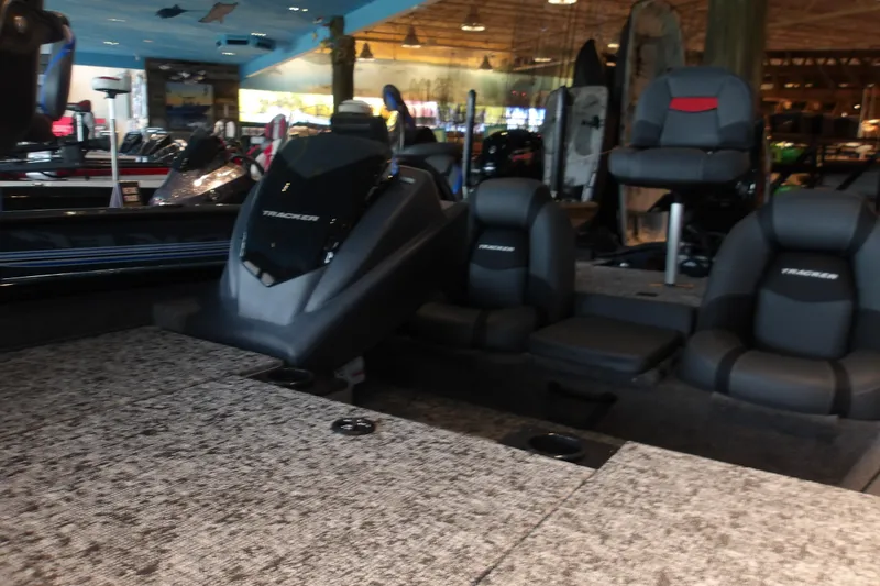 Slide: The Image of 2026 Tracker Pro Team 190 boat interior with seating and console in showroom. - 6