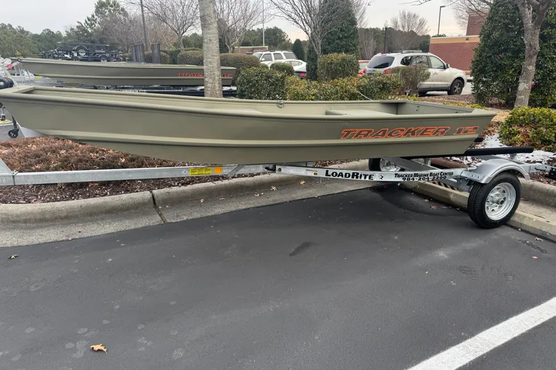 The Image of 2026 Tracker Grizzly 12 Jon boat on LoadRite trailer in parking lot. - 0