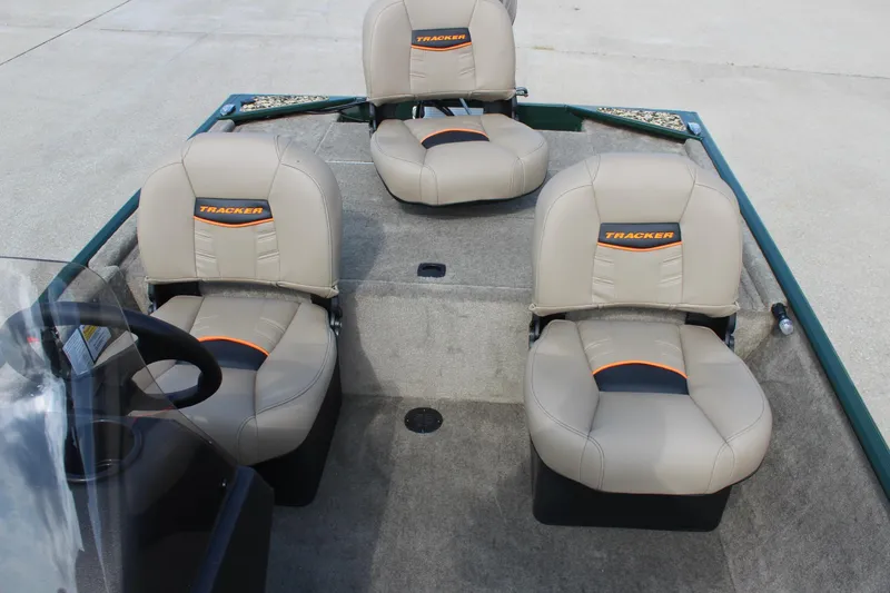 Slide: The Image of 2026 Tracker Bass Tracker Classic Limited boat interior with three beige seats. - 15
