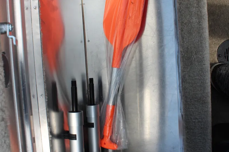 Slide: The Image of 2026 Tracker Bass Tracker Classic Limited boat accessories, including orange paddles and metal rods. - 16