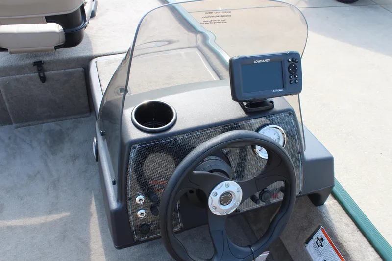 Slide: The Image of 2026 Tracker Bass Tracker Classic Limited boat dashboard with steering wheel and fish finder. - 17