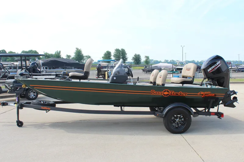 Slide: The Image of 2026 Tracker Bass Tracker Classic Limited boat on trailer, side view, outdoors. - 4