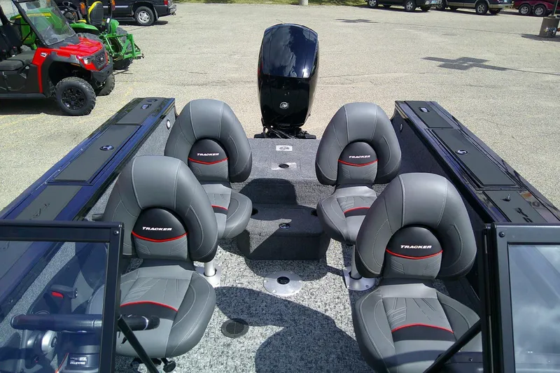 Slide: The Image of 2026 Tracker Targa V-18 WT boat interior with four gray seats and motor. - 2