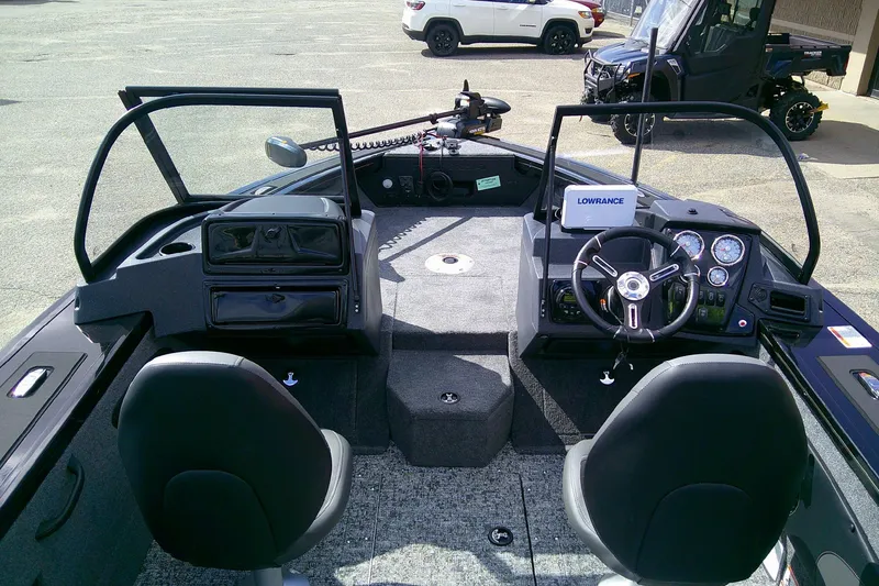 Slide: The Image of 2026 Tracker Targa V-18 WT boat interior with steering console and seating. - 3