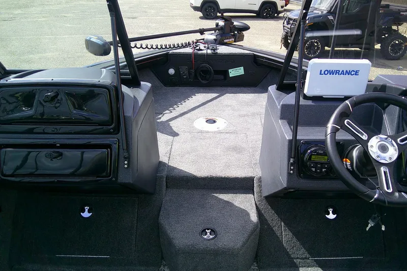 Slide: The Image of 2026 Tracker Targa V-18 WT boat interior with steering wheel and Lowrance equipment. - 4