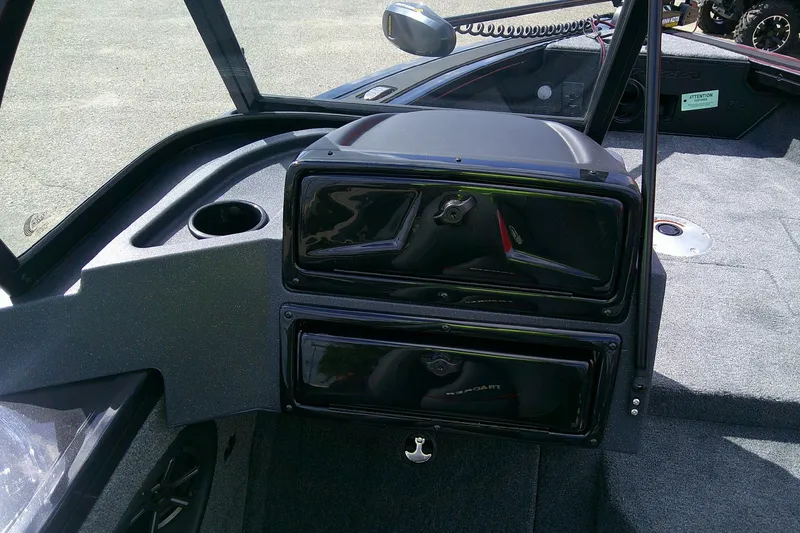 Slide: The Image of 2026 Tracker Targa V-18 WT boat interior with storage compartments and cup holder. - 6