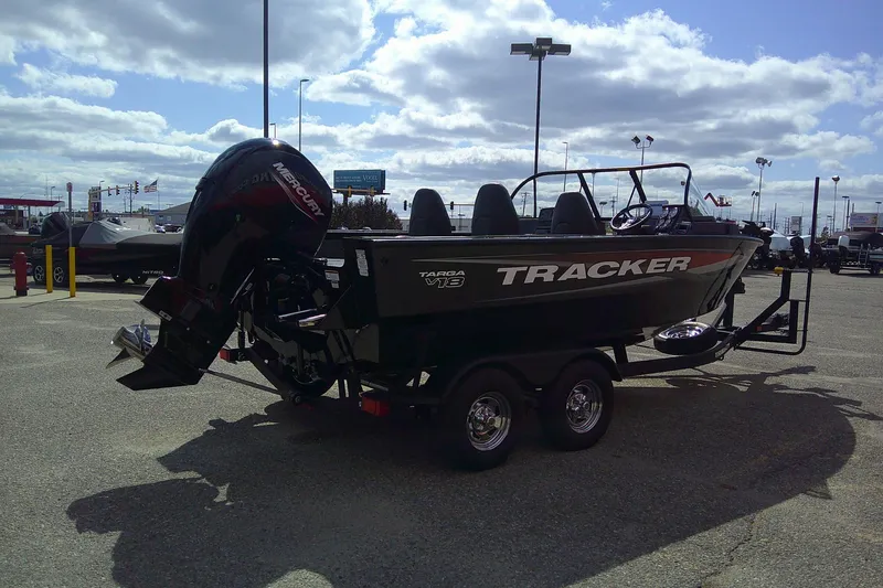 Slide: The Image of 2026 Tracker Targa V-18 WT boat on trailer in parking lot under cloudy sky. - 90