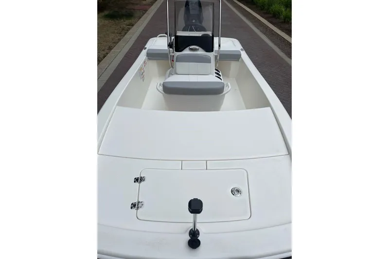 Slide: The Image of 2026 Mako Pro Skiff 13 CC boat interior with center console and seating. - 4