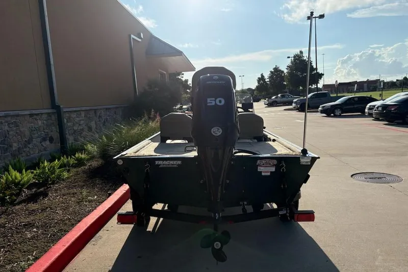 Slide: The Image of 2026 Tracker Bass Tracker Classic Limited boat parked outdoors, rear view. - 7