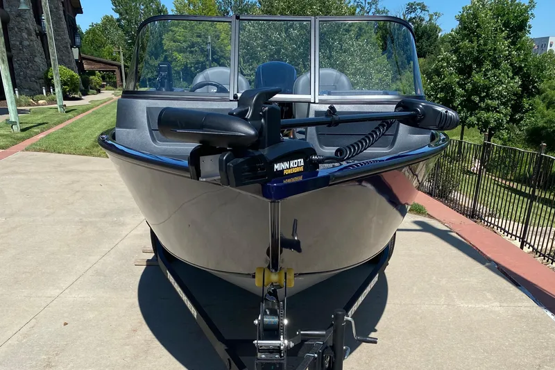 Slide: The Image of 2026 Tracker Pro Guide V-16 WT boat on trailer, featuring Minn Kota motor. - 2