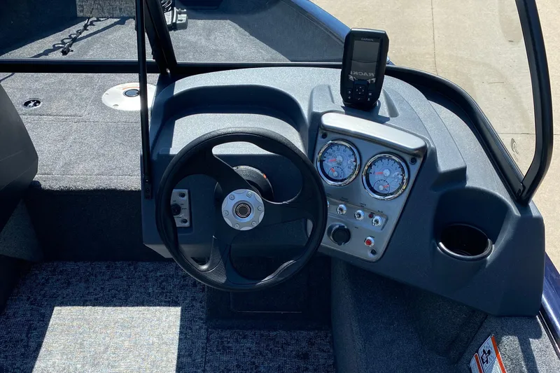 Slide: The Image of 2026 Tracker Pro Guide V-16 WT boat dashboard with steering wheel and gauges. - 5