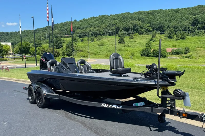 Slide: The Image of 2026 Nitro Z20 XL Pro boat on trailer, parked outdoors with green landscape background. - 3