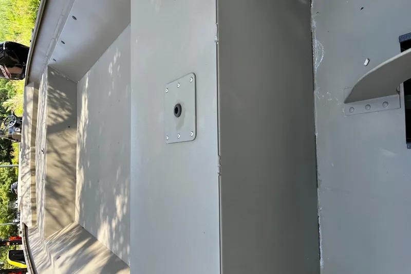 Slide: The Image of 2026 Tracker GRIZZLY 2072 Utility boat interior with metal flooring and seating. - 2