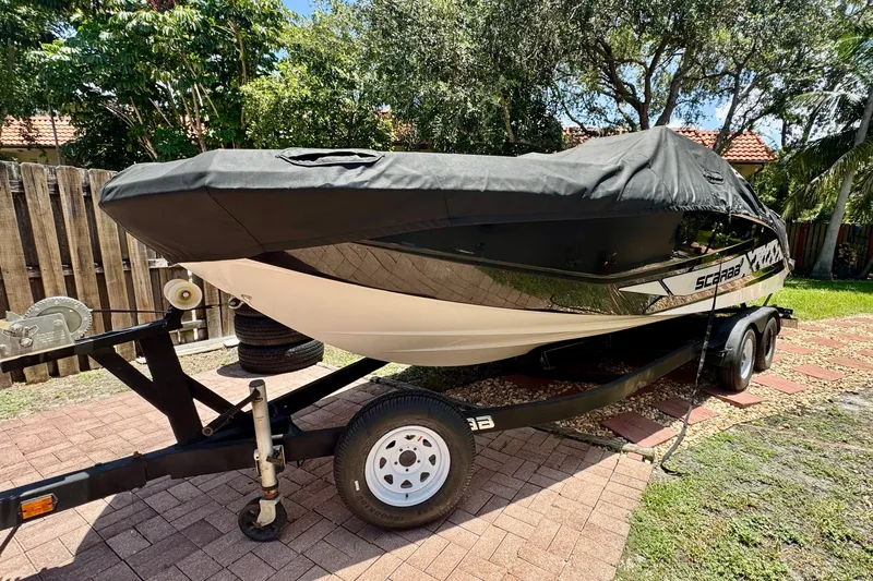 The Image of 2019 Scarab 255 ID boat on trailer, covered, parked outdoors. - 12