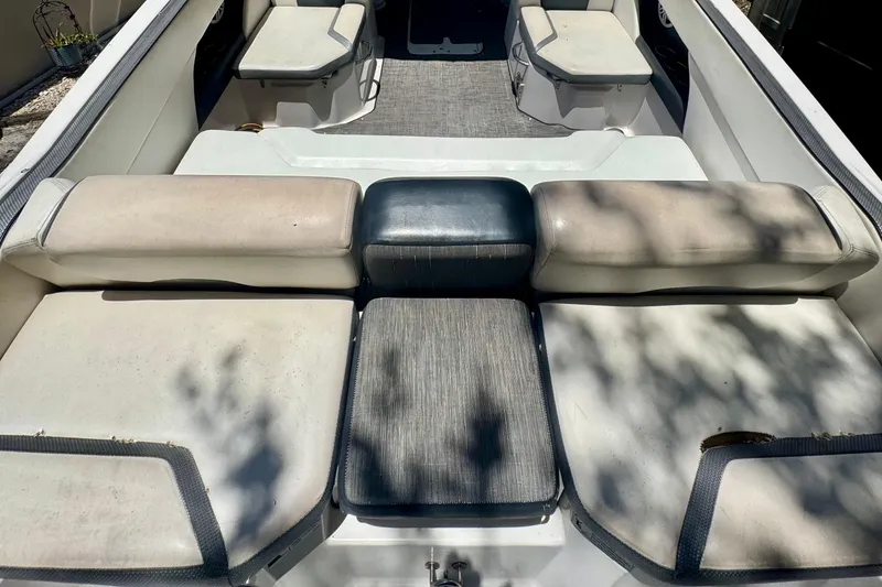 Slide: The Image of 2019 Scarab 255 ID boat interior with cushioned seating and carpeted flooring. - 15