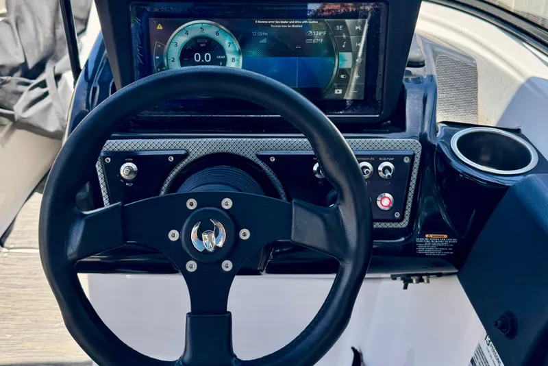 Slide: The Image of Steering wheel and dashboard of 2019 Scarab 255 ID boat with digital display. - 16