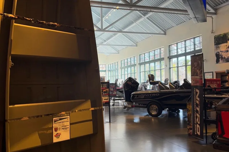The Image of 2026 Tracker Grizzly 10 Jon boat displayed in a showroom with other boats. - 0