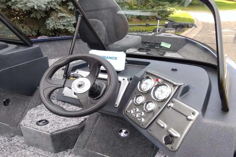 Slide: The Image of 2026 Tracker Pro Guide V-175 WT boat dashboard with steering wheel and instrument panel. - 7