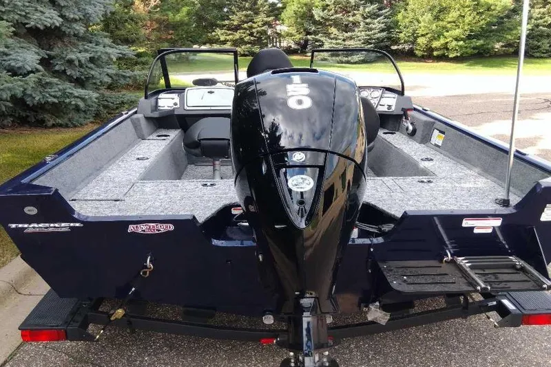 Slide: The Image of 2026 Tracker Pro Guide V-175 WT boat with powerful outboard motor, parked outdoors. - 8