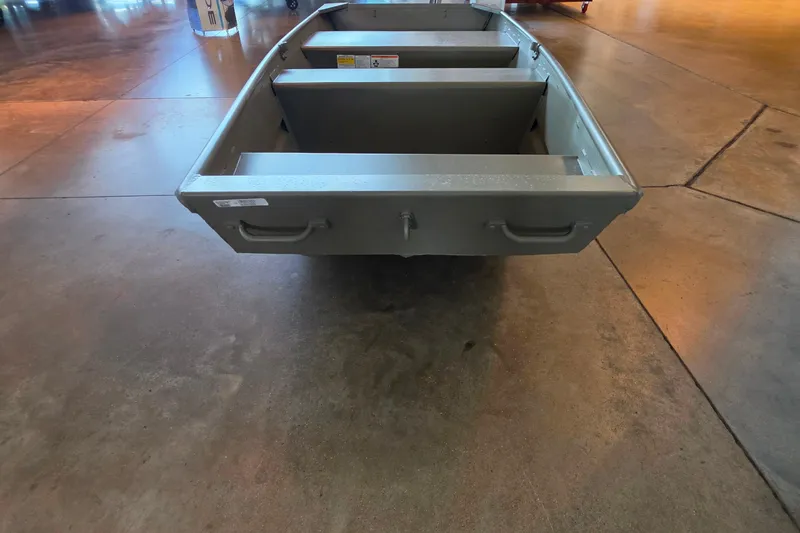 The Image of 2026 Tracker Grizzly 12 Jon boat displayed indoors on polished concrete floor. - 0