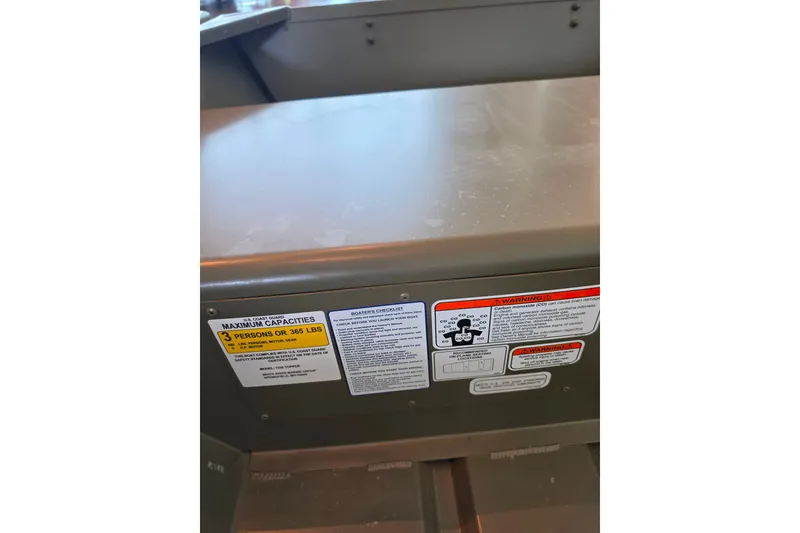 Slide: The Image of 2026 Tracker Grizzly 12 Jon boat capacity and safety labels, maximum 3 persons or 365 lbs. - 3