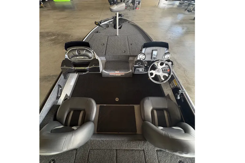 Slide: The Image of 2026 Nitro Z17 boat interior with dual seats and steering console in showroom. - 7