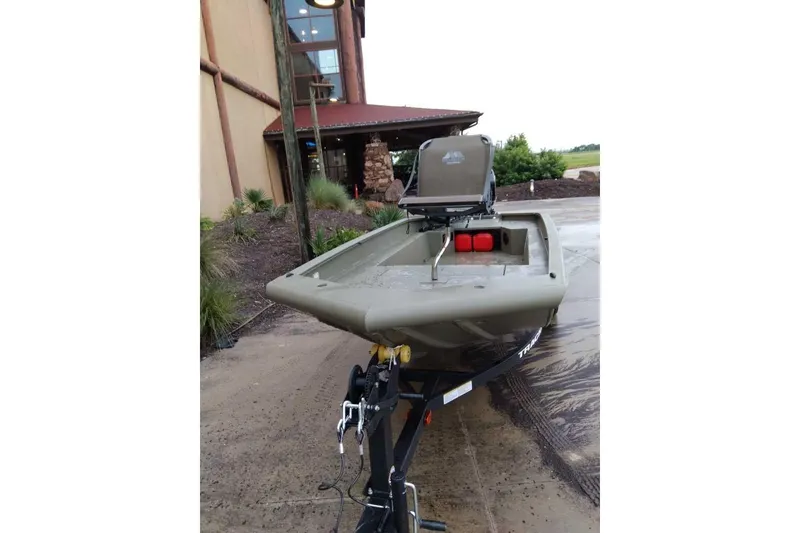 Slide: The Image of 2026 Tracker Grizzly 1650 T Prairie Wings Edition boat on trailer, parked outdoors. - 35