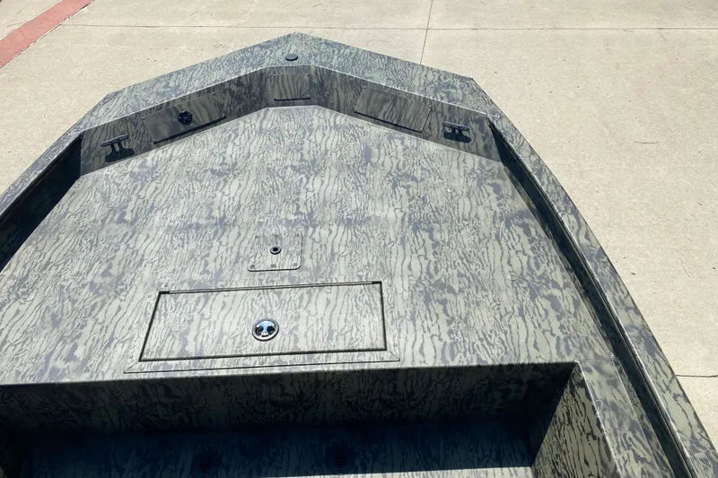 Slide: The Image of 2026 Tracker Grizzly 1860 CC boat with camouflage pattern on concrete surface. - 3