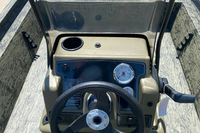 Slide: The Image of 2026 Tracker Grizzly 1860 CC boat console with steering wheel and gauges. - 5