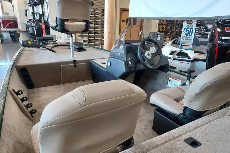 Slide: The Image of 2026 Tracker Bass Tracker Classic Limited boat interior with steering console and seating. - 2