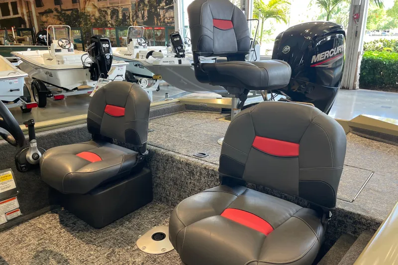 Slide: The Image of 2026 Tracker Pro Team 175 Crappie Edition boat interior with Mercury engine in showroom. - 7