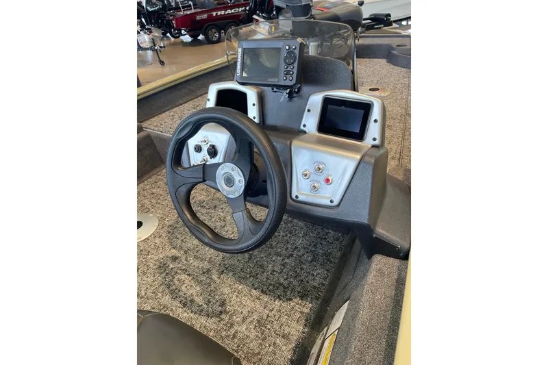Slide: The Image of Steering console of 2026 Tracker Pro Team 175 Crappie Edition boat with navigation controls. - 3
