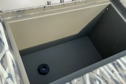 Slide: The Image of 2026 Tracker Grizzly 15 Jon boat storage compartment, open and empty. - 4