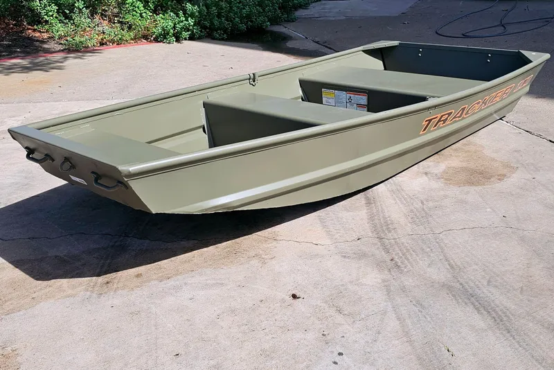 Slide: The Image of 2026 Tracker Grizzly 12 Jon boat on concrete surface, showcasing its sturdy design. - 43