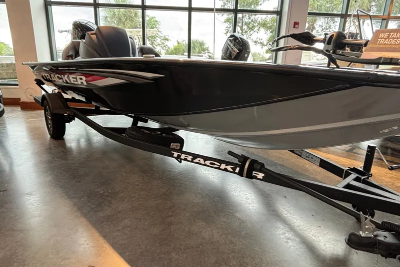 The Image of 2026 Tracker Pro Team 190 boat on display indoors with trailer. - 0