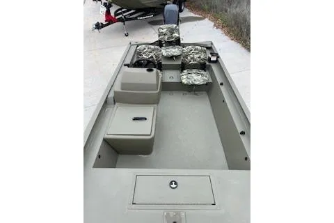 Slide: The Image of 2026 Tracker Grizzly 1754 SC boat interior with camo seats and storage compartments. - 31