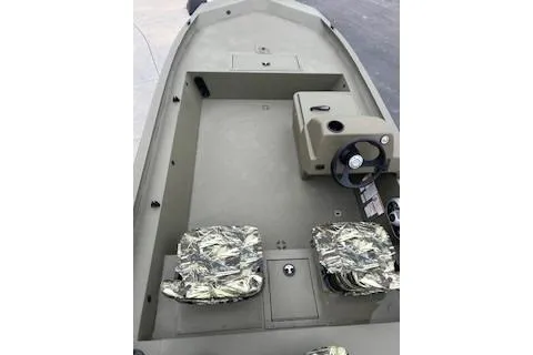 Slide: The Image of 2026 Tracker Grizzly 1754 SC boat interior with camo seats and steering console. - 34