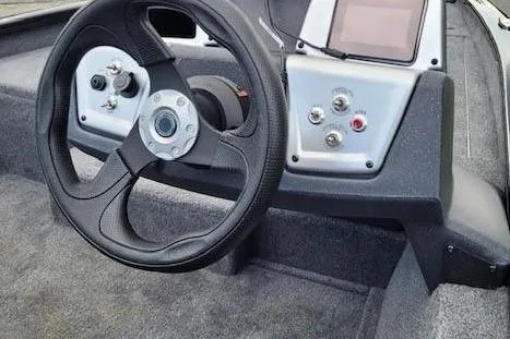 Slide: The Image of 2026 Tracker Pro Team 175 boat dashboard with steering wheel and control panel. - 2
