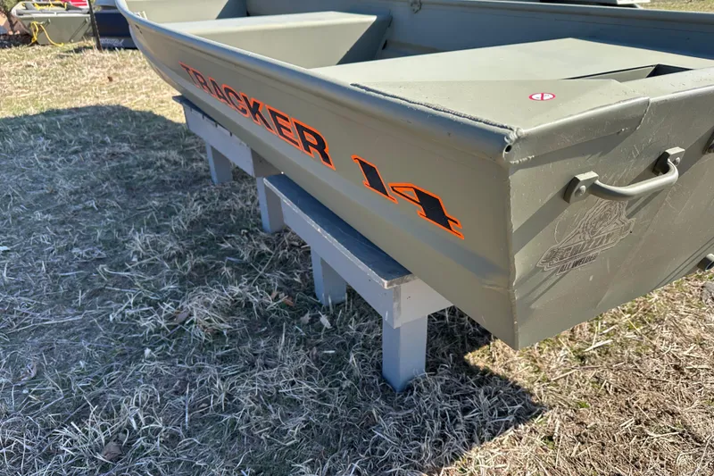 Slide: The Image of 2026 Tracker Grizzly 14 Jon boat on grass, showcasing sturdy design and branding. - 10