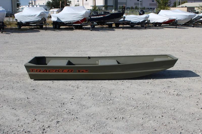 The Image of 2026 Tracker Grizzly 12 Jon boat displayed outdoors on gravel lot. - 0