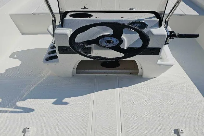 Slide: The Image of 2026 Mako Pro Skiff 15 CC boat console with steering wheel and controls. - 4