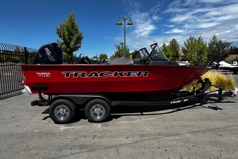 The Image of 2026 Tracker Targa V-18 Combo boat on trailer, parked outdoors under clear sky. - 0