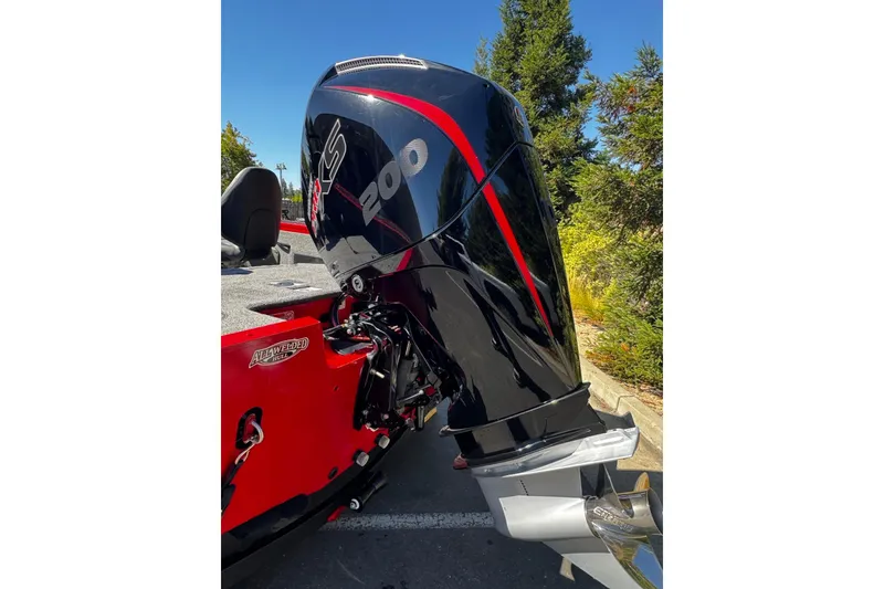 Slide: The Image of 2026 Tracker Targa V-18 Combo boat with powerful 200 HP outboard motor, parked outdoors. - 10
