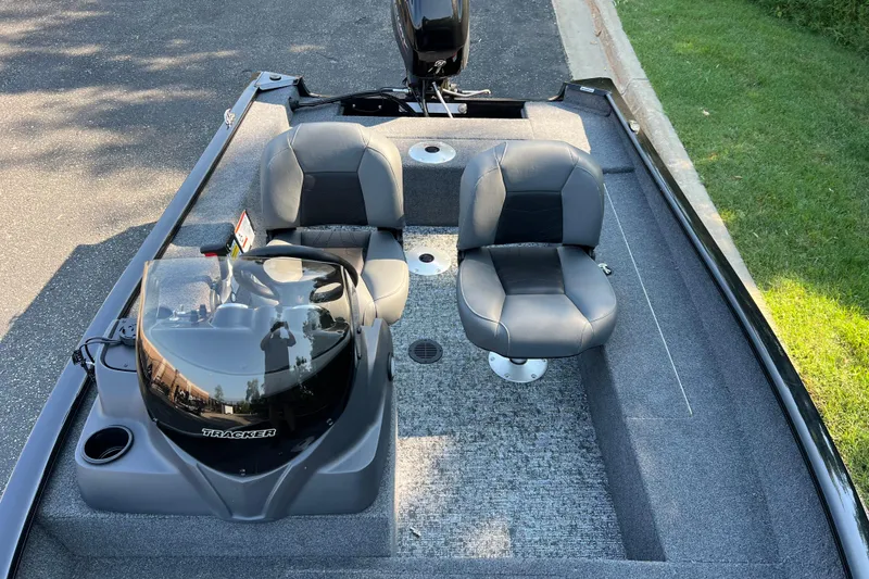 Slide: The Image of 2026 Tracker Super Guide V-16 SC boat interior with dual seats and console. - 3