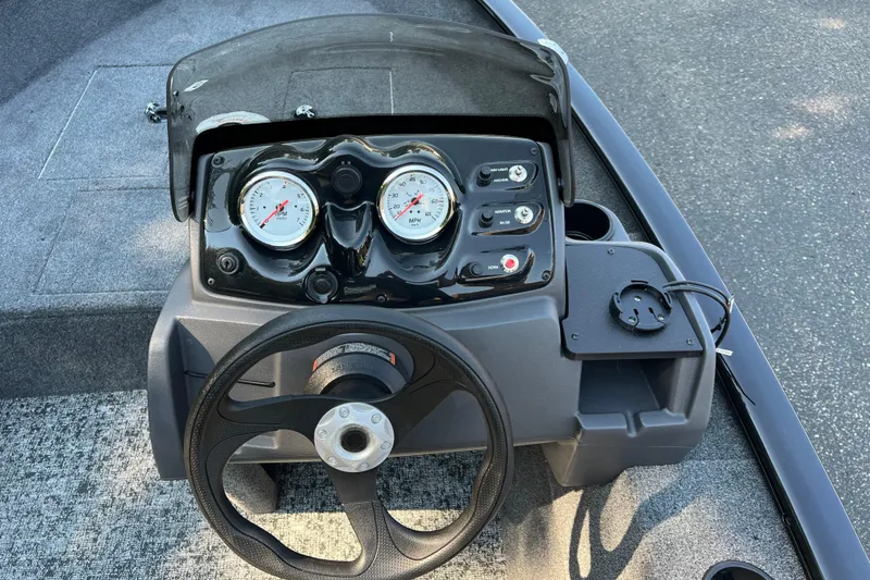 Slide: The Image of Steering console of 2026 Tracker Super Guide V-16 SC boat with gauges and controls. - 4