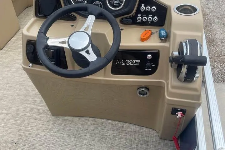 Slide: The Image of Steering console of 2018 Lowe SS230 Walk-Thru boat with controls and gauges. - 10